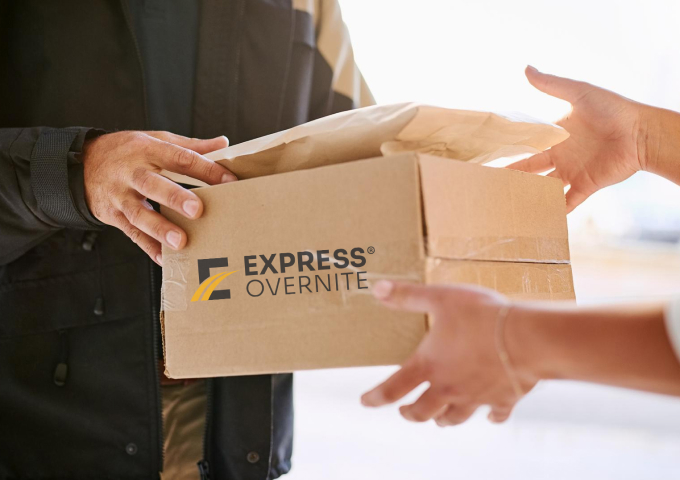 Delivery driver passing packages to client