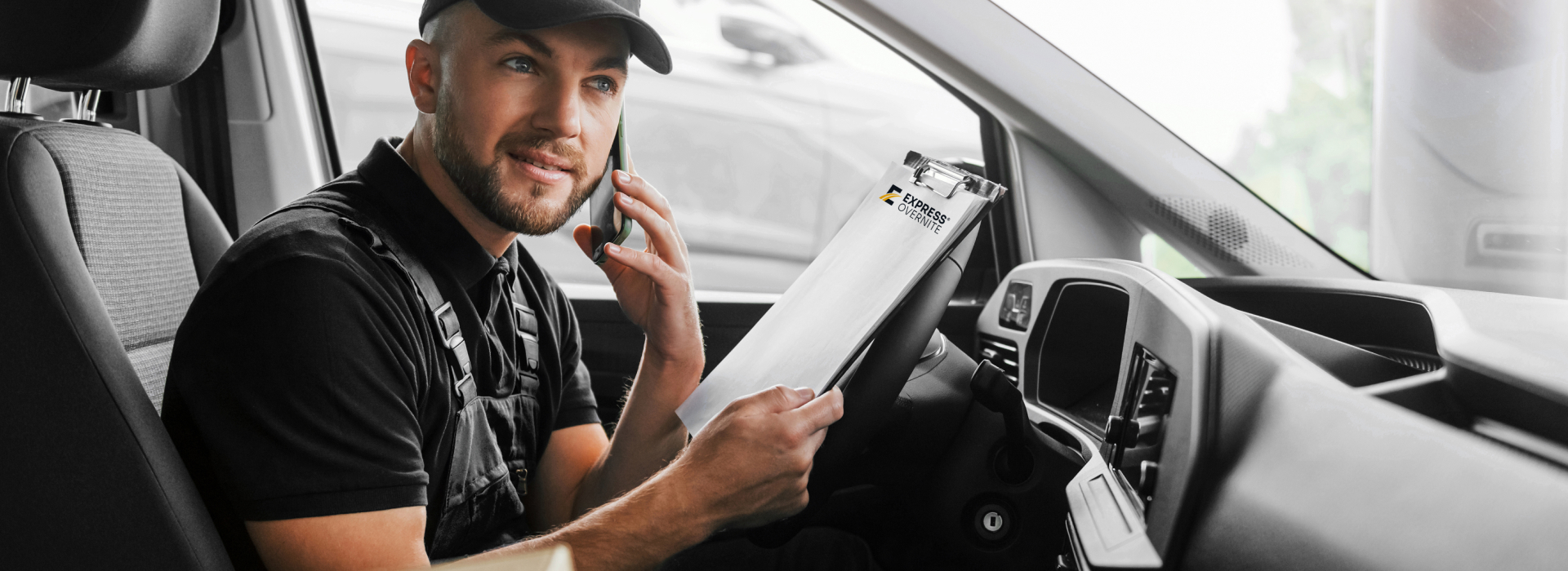 Driver in van on phone conrming a delivery