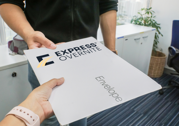 Man accepting Express Overnite envelope