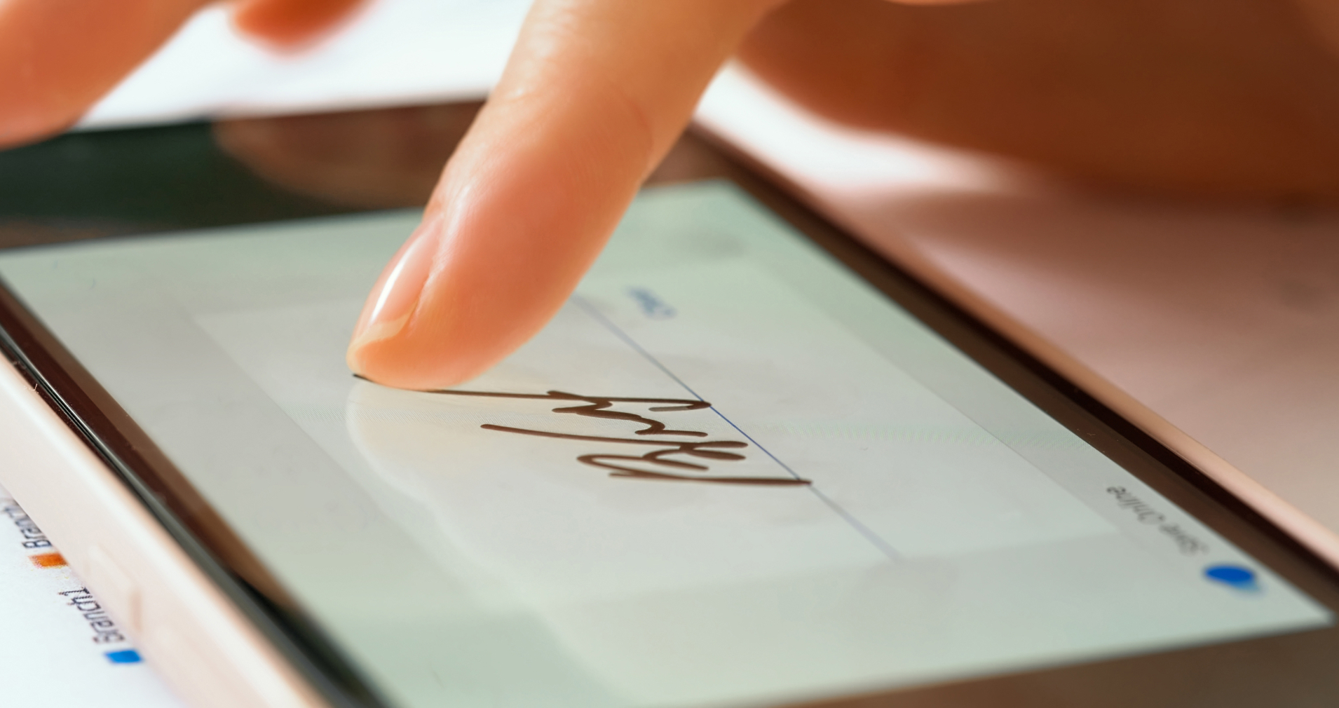 Person’s finger signing a tablet to verify service delivery